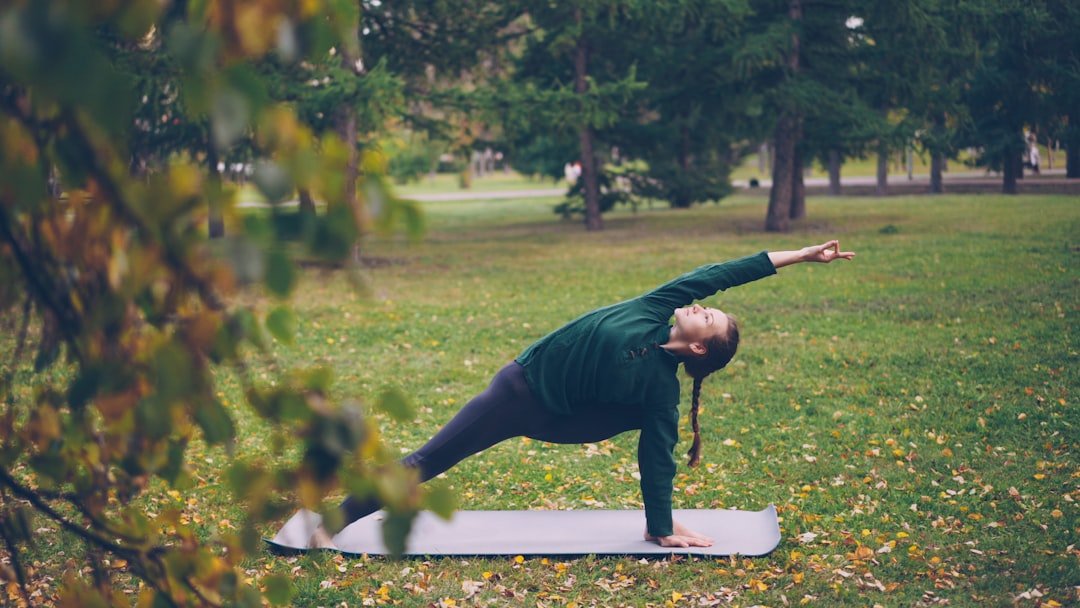 Tree pose practiced outdoors in calm light