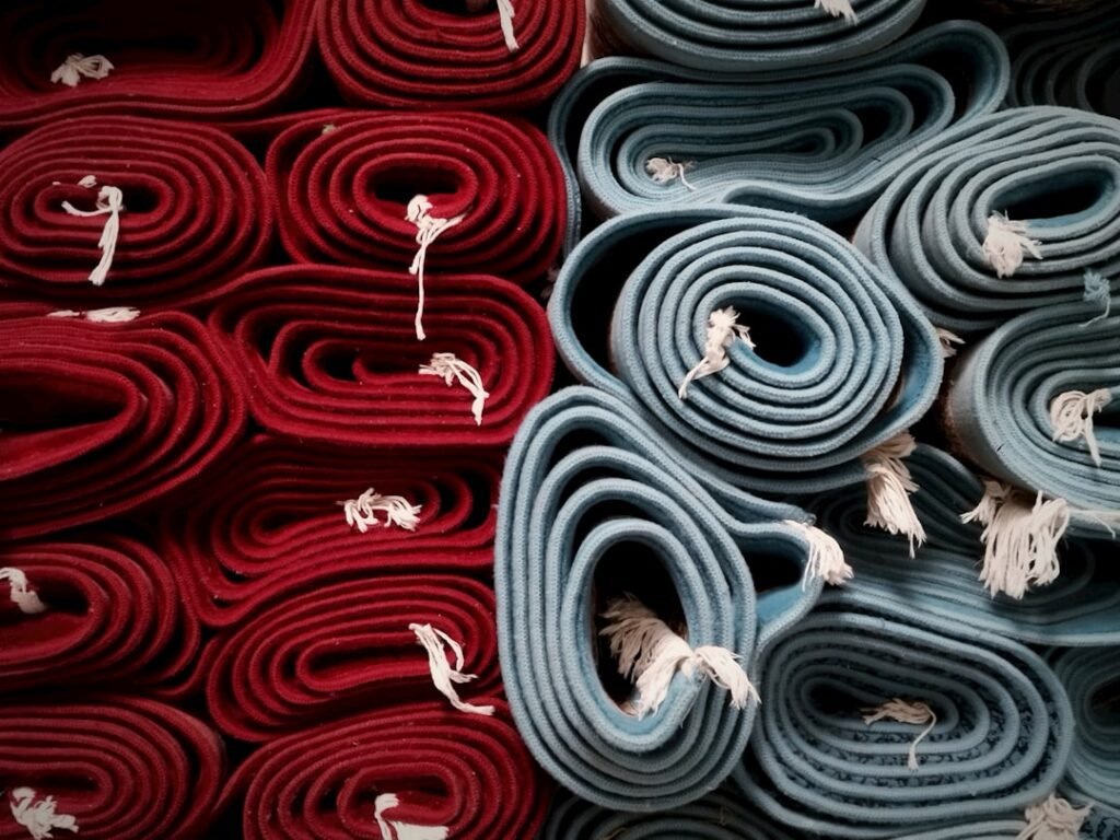 Stack of yoga mats in varying colors and textures
