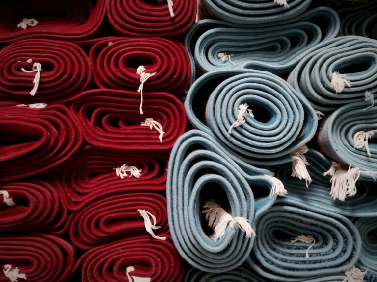 Stack of yoga mats in varying colors and textures