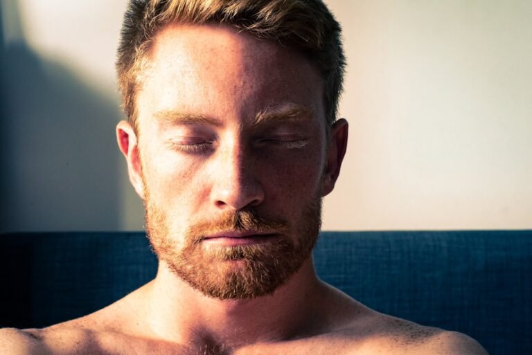 Person meditating with eyes closed in calm natural light