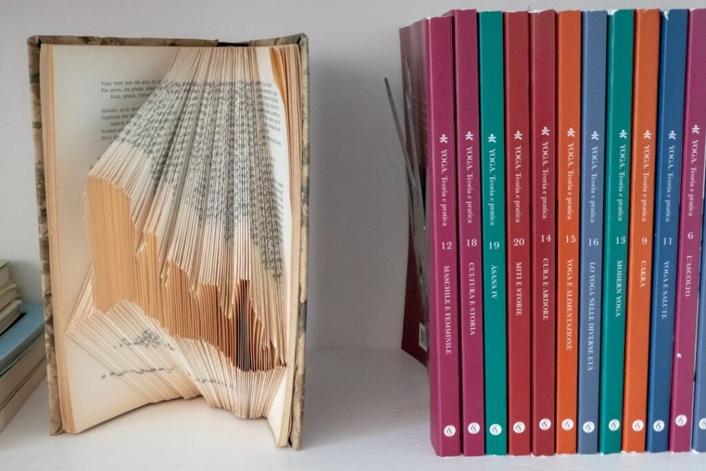 Stack of yoga philosophy books in natural light