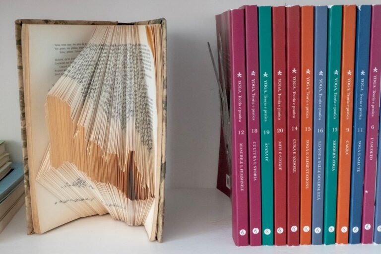 Stack of yoga philosophy books in natural light