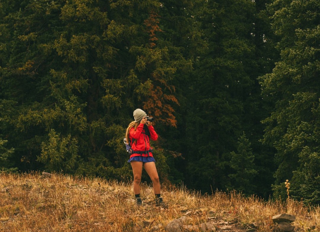 Runner stretching hamstrings on an outdoor trail
